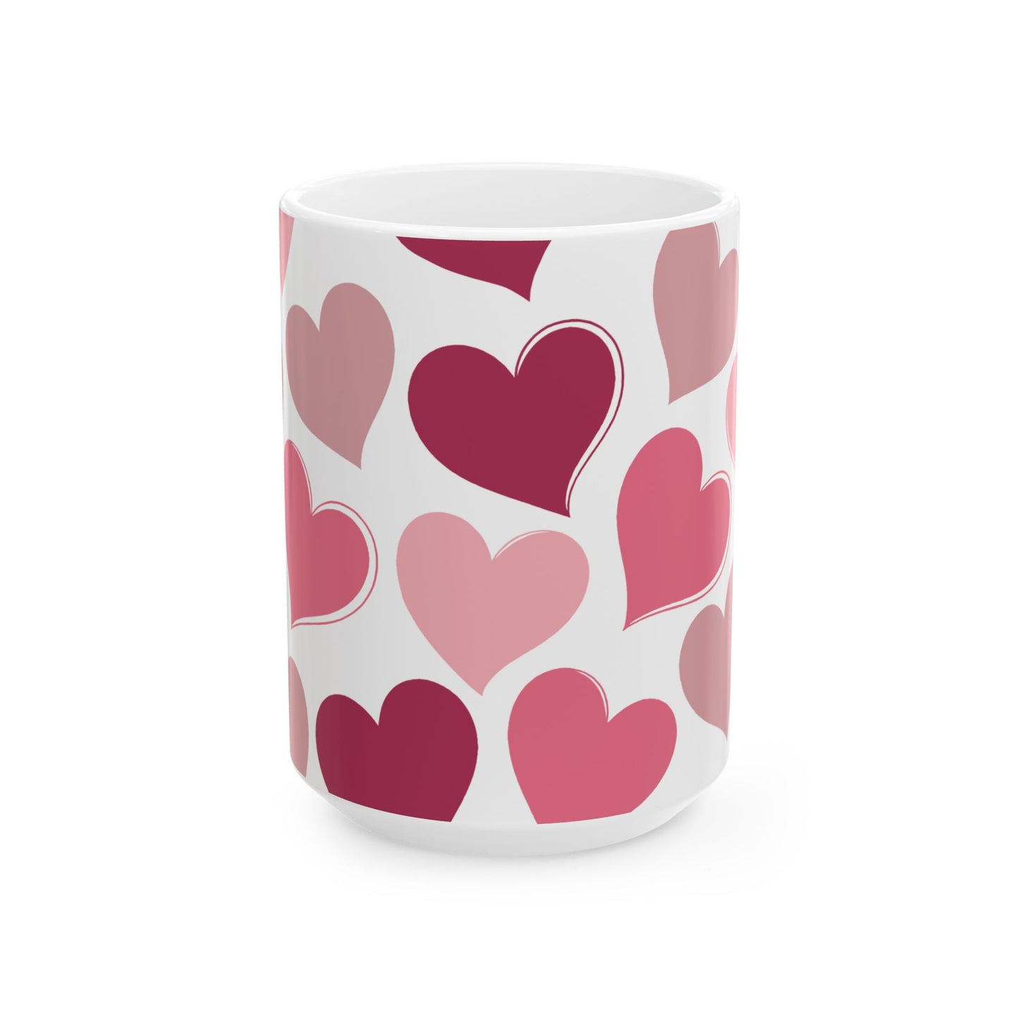 White mug with pink and red heart pattern on a white background